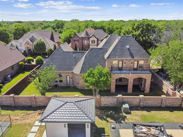 an aerial view of multiple houses with a yard