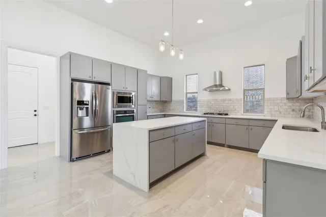 a kitchen with a sink stainless steel appliances and counter space