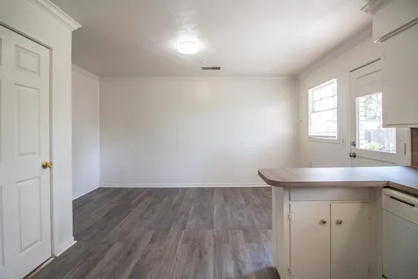 a room with wooden floor and window