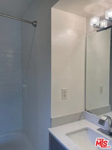 a bathroom with a sink and shower