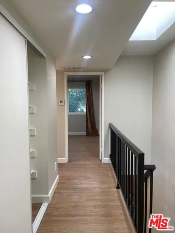 a view of hallway with wooden floor