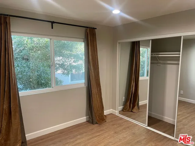 a view of a room with wooden floor and windows