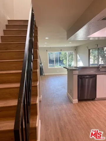a view of kitchen and hall with wooden floor