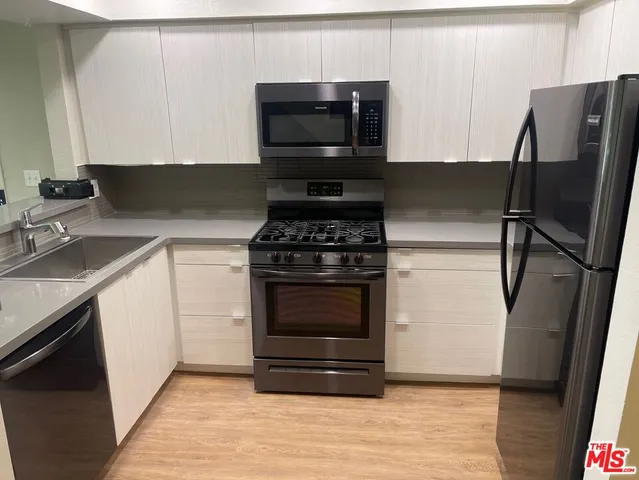 a kitchen with a refrigerator stove and microwave