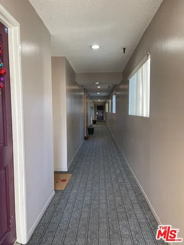 a view of hallway with wooden floor