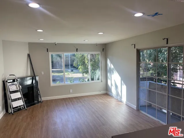 a view of entryway with wooden floor and windows