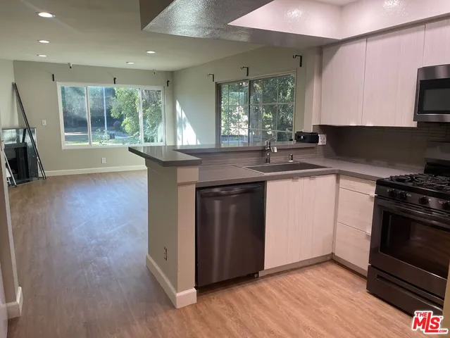 a kitchen with a sink stove and cabinets
