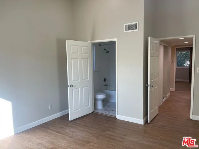 a view of a room with wooden floor