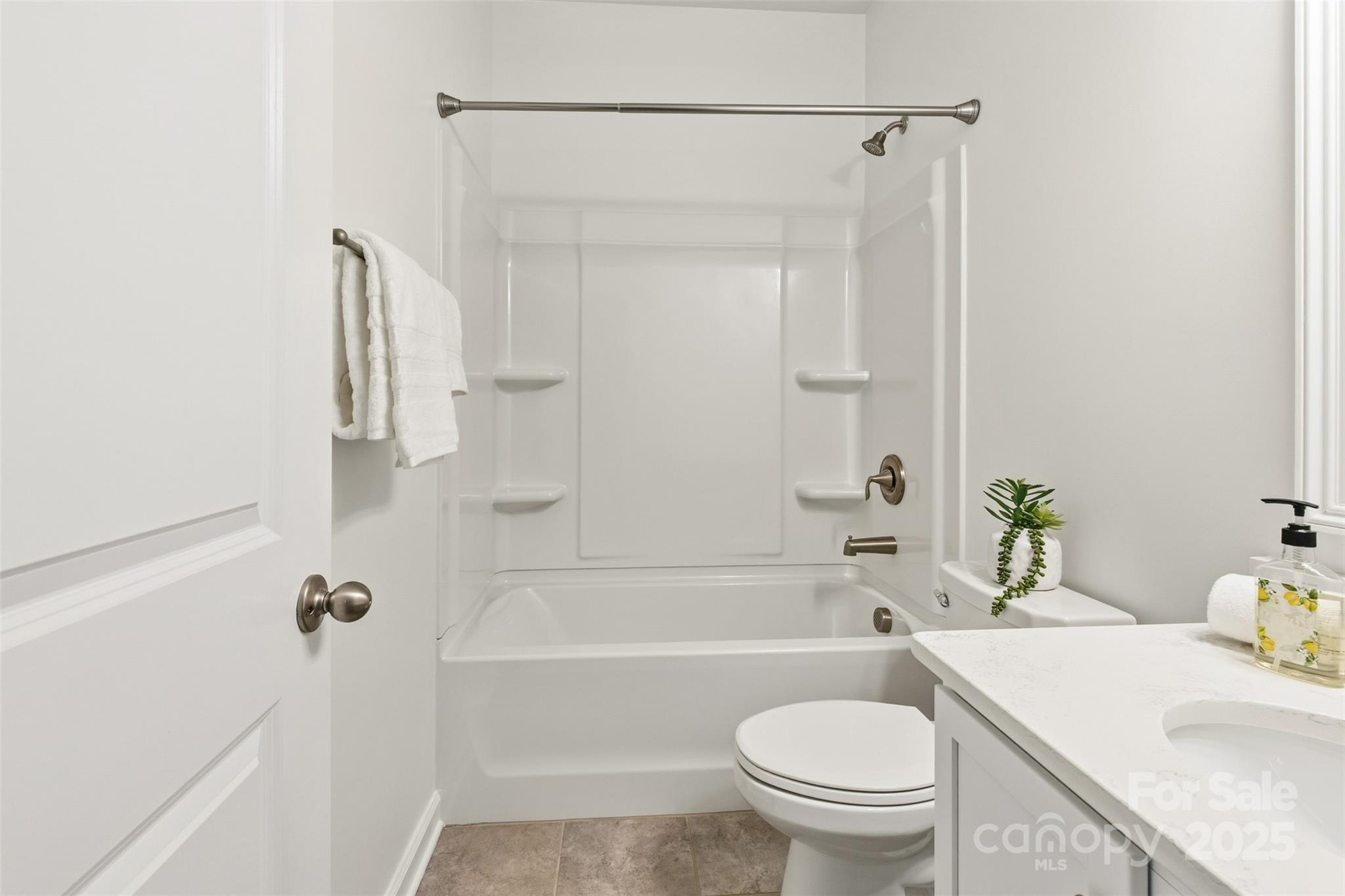 16714 Setter Point Lane Davidson, NC 28036 - Photo 15 of 29 a bathroom with a sink a toilet and a bathtub