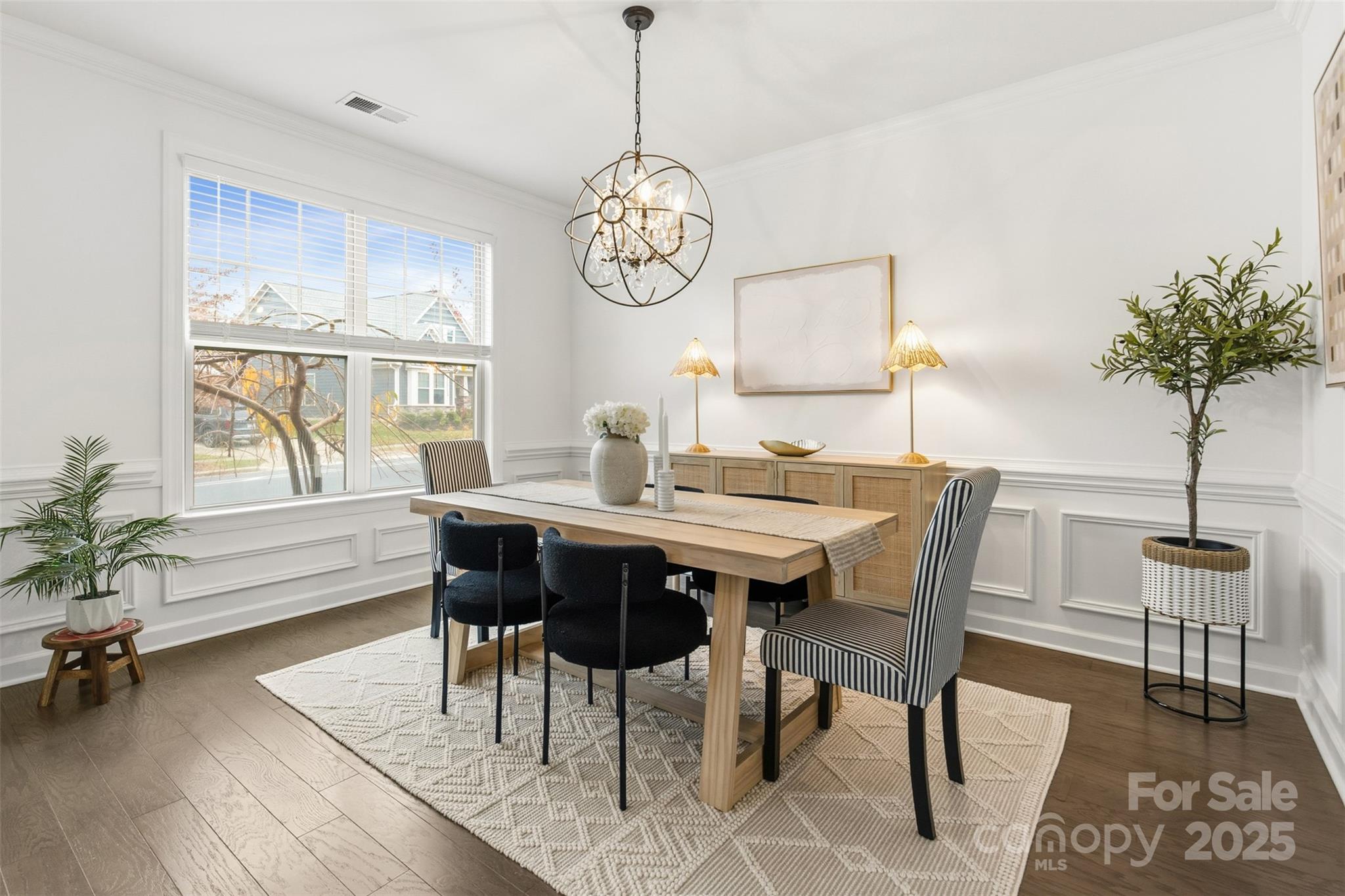 16714 Setter Point Lane Davidson, NC 28036 - Photo 4 of 29 a dining room with wooden floor a chandelier a wooden table and chairs