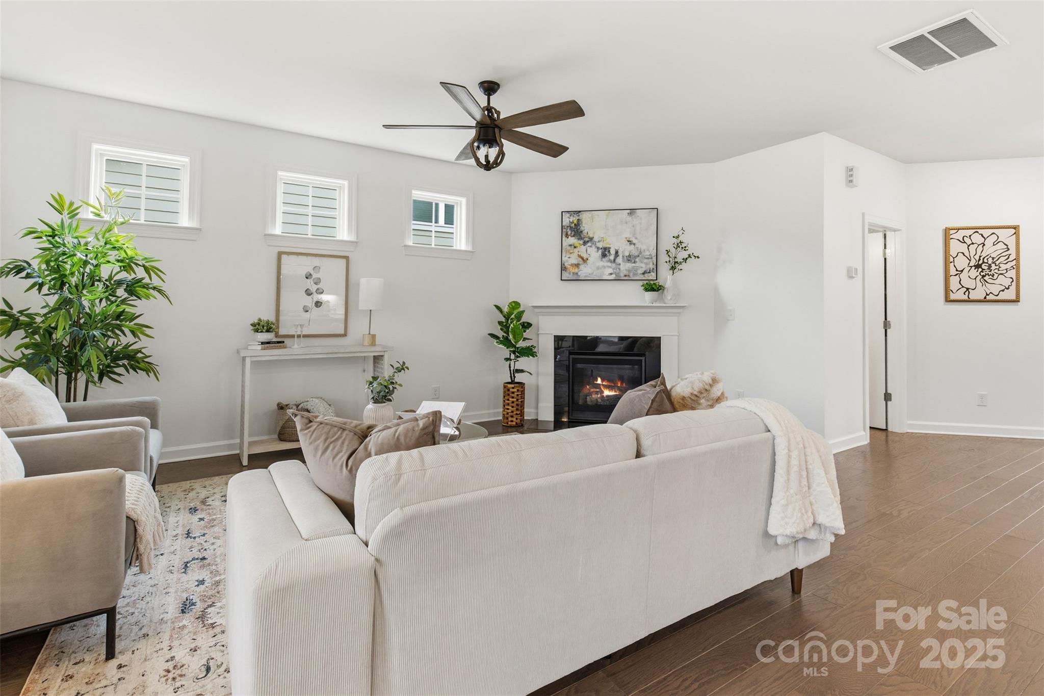 16714 Setter Point Lane Davidson, NC 28036 - Photo 9 of 29 a living room with furniture a fireplace and a potted plant
