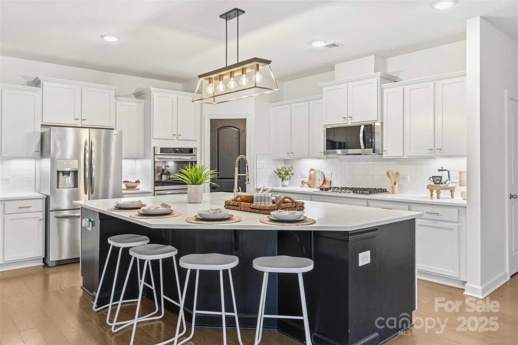 16714 Setter Point Lane Davidson, NC 28036 - Photo 10 of 29 a kitchen with stainless steel appliances granite countertop a sink a stove a refrigerator and white cabinets