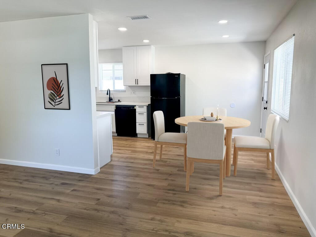 1805 MacArthur Place Oxnard, CA 93033 - Photo 11 of 23 a view of a dining room with furniture and wooden floor
