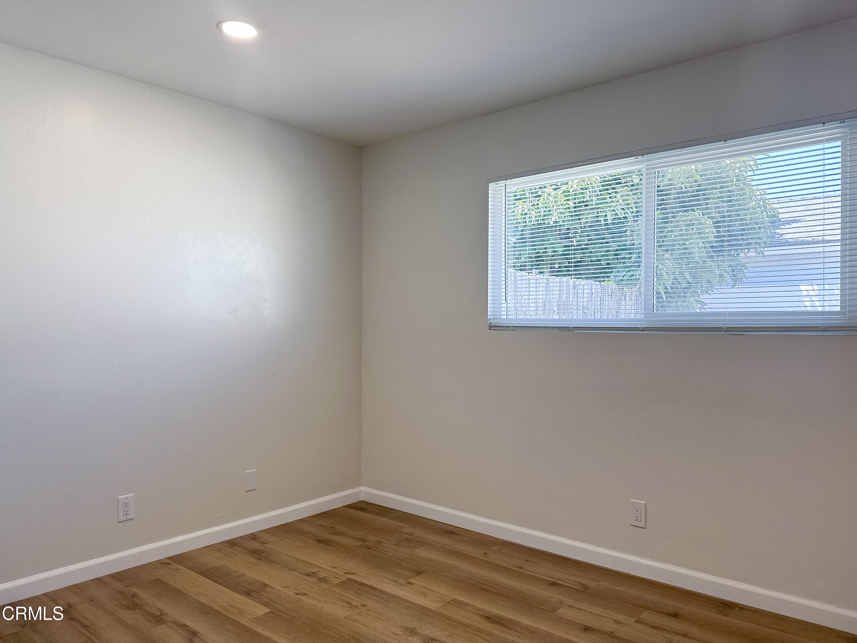 1805 MacArthur Place Oxnard, CA 93033 - Photo 15 of 23 an empty room with wooden floor and windows