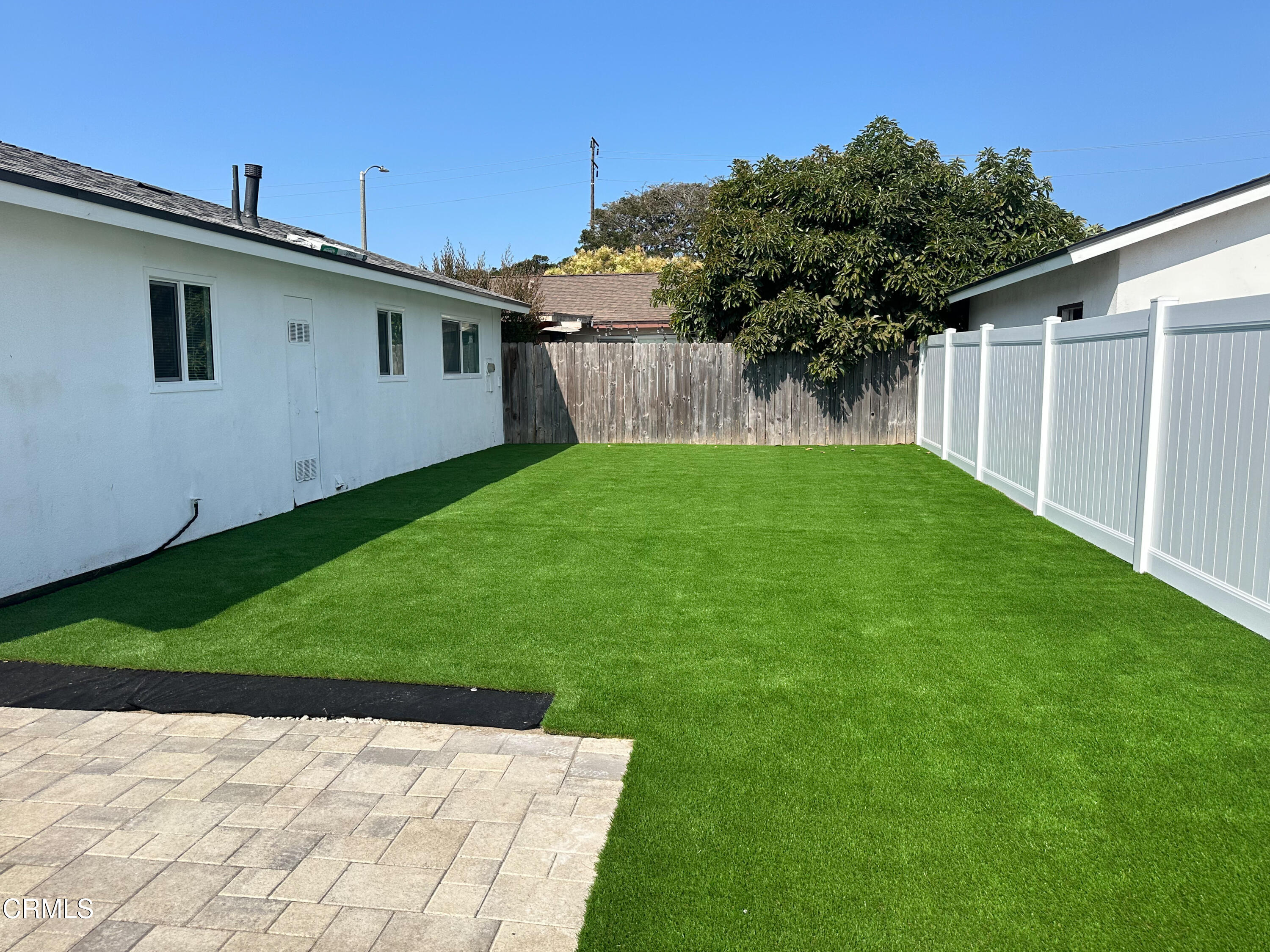 1805 MacArthur Place Oxnard, CA 93033 - Photo 20 of 23 a backyard of a house with plants and wooden fence