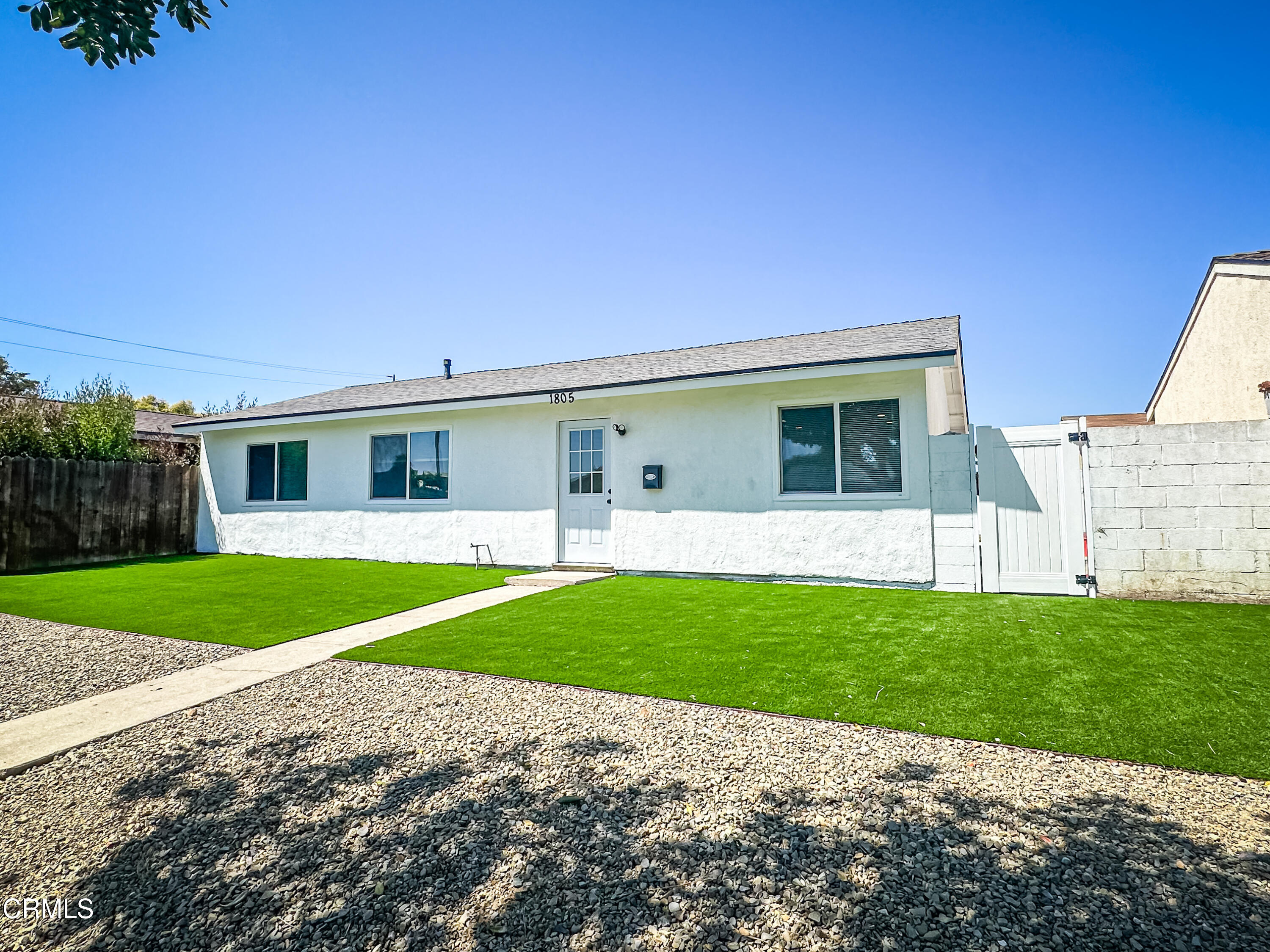 1805 MacArthur Place Oxnard, CA 93033 - Photo 2 of 23 a front view of a house with a yard and garage