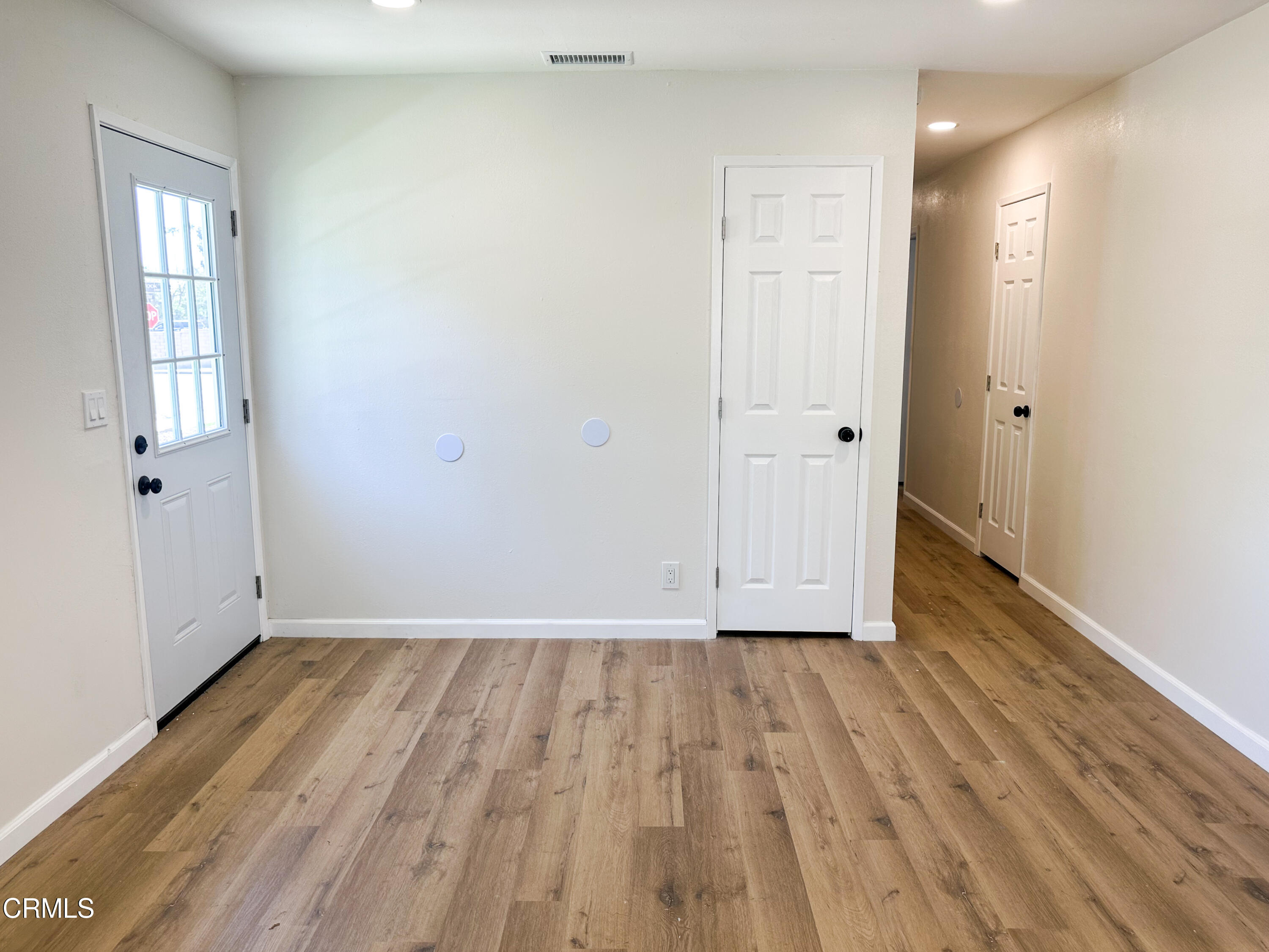 1805 MacArthur Place Oxnard, CA 93033 - Photo 3 of 23 a view of an empty room with wooden floor and a window