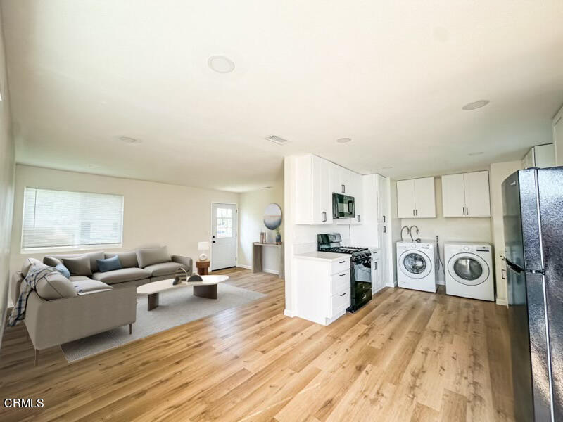 1805 MacArthur Place Oxnard, CA 93033 - Photo 4 of 23 a living room with furniture a flat screen tv and a refrigerator
