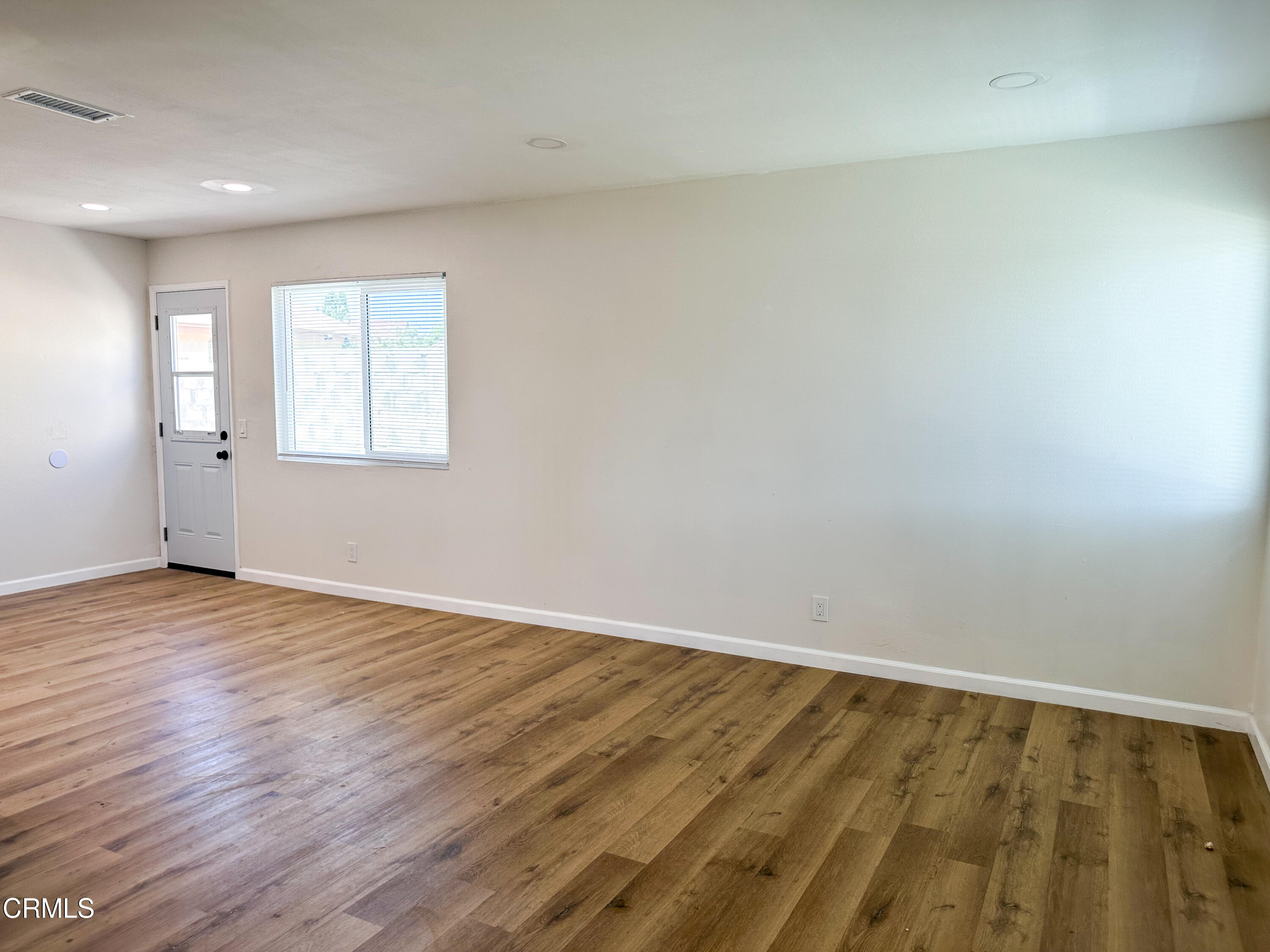 1805 MacArthur Place Oxnard, CA 93033 - Photo 5 of 23 wooden floor in an empty room with a window