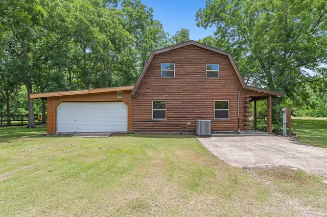 a kitchen with kitchen island granite countertop a sink a counter top space and cabinets