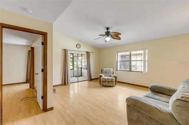 an empty room with a ceiling fan and a window