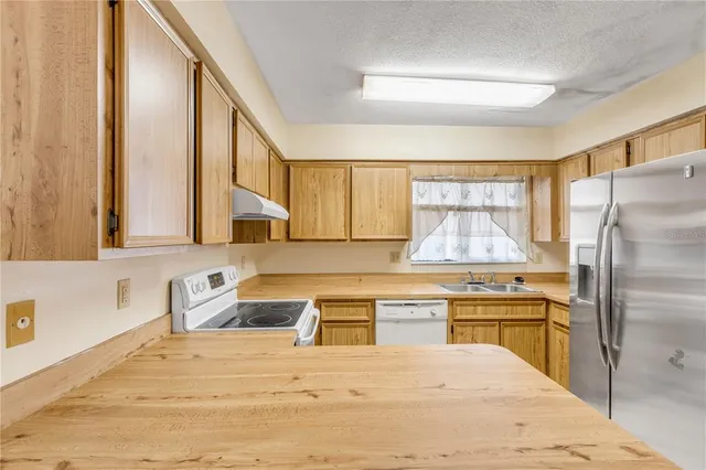 a kitchen with a stove a sink and a microwave