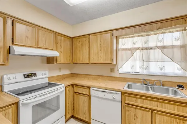 a kitchen with a stove top oven sink and cabinets