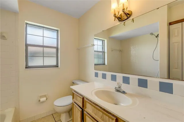 a view of a room with a ceiling fan