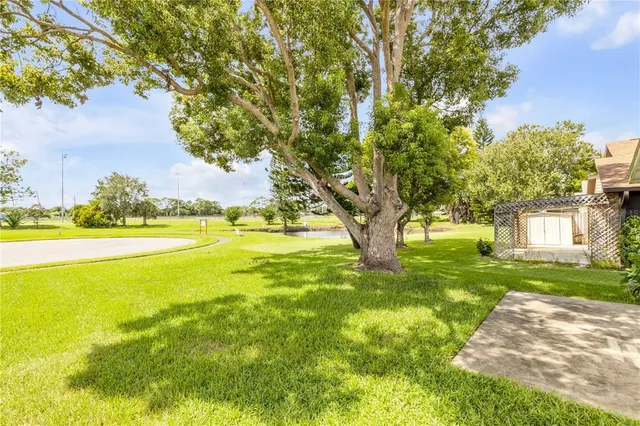 aerial view of a swimming pool with a yard