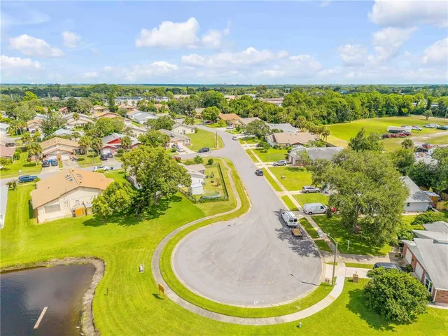 an aerial view of residential houses with outdoor space and river