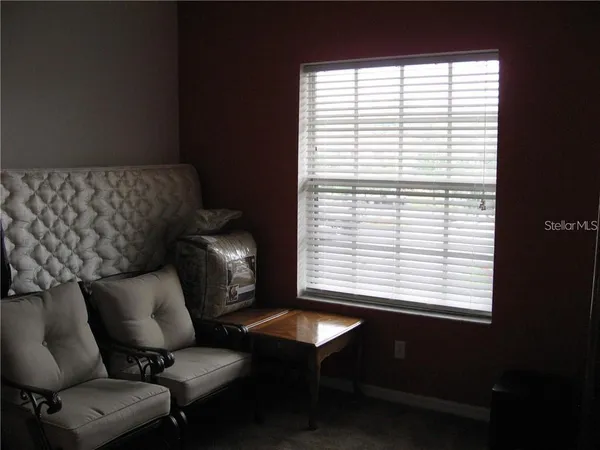 a blue chair sitting in front of a window
