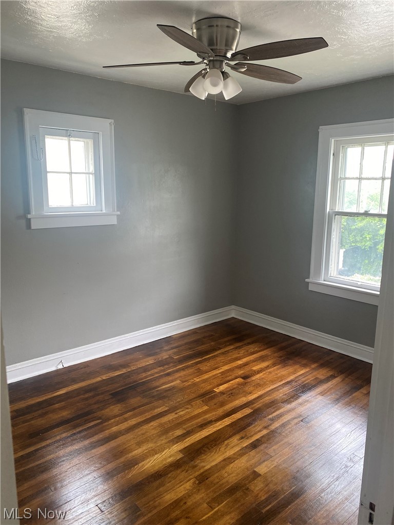 4688 Rockwood Road Cleveland, OH 44125 - Photo 31 of 35 Hardwood floored empty room featuring a textured ceiling, plenty of natural light, and ceiling fan