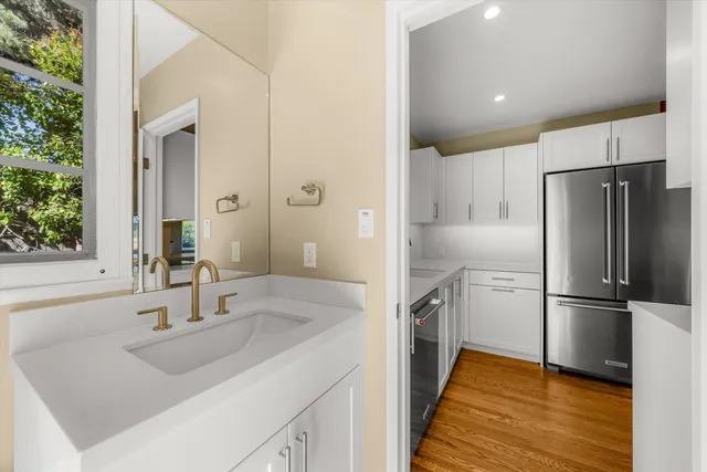 a kitchen with kitchen island a sink appliances and cabinets