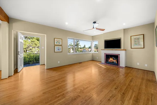 a view of an empty room with a fireplace and a window