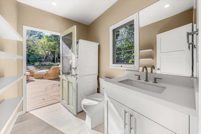 a bathroom with a sink toilet and a mirror
