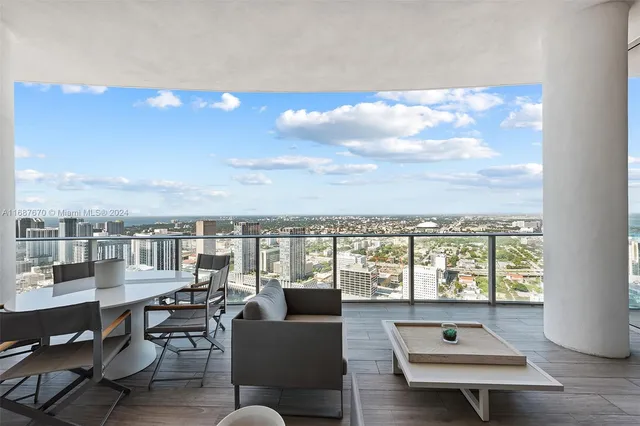 a bedroom with a large bed and a large window