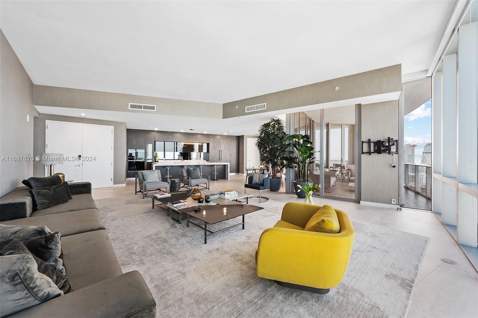 851 Northeast 1st Avenue, Unit PH5112 Miami, FL 33132 - Photo 2 of 77 a living room with furniture and a large window