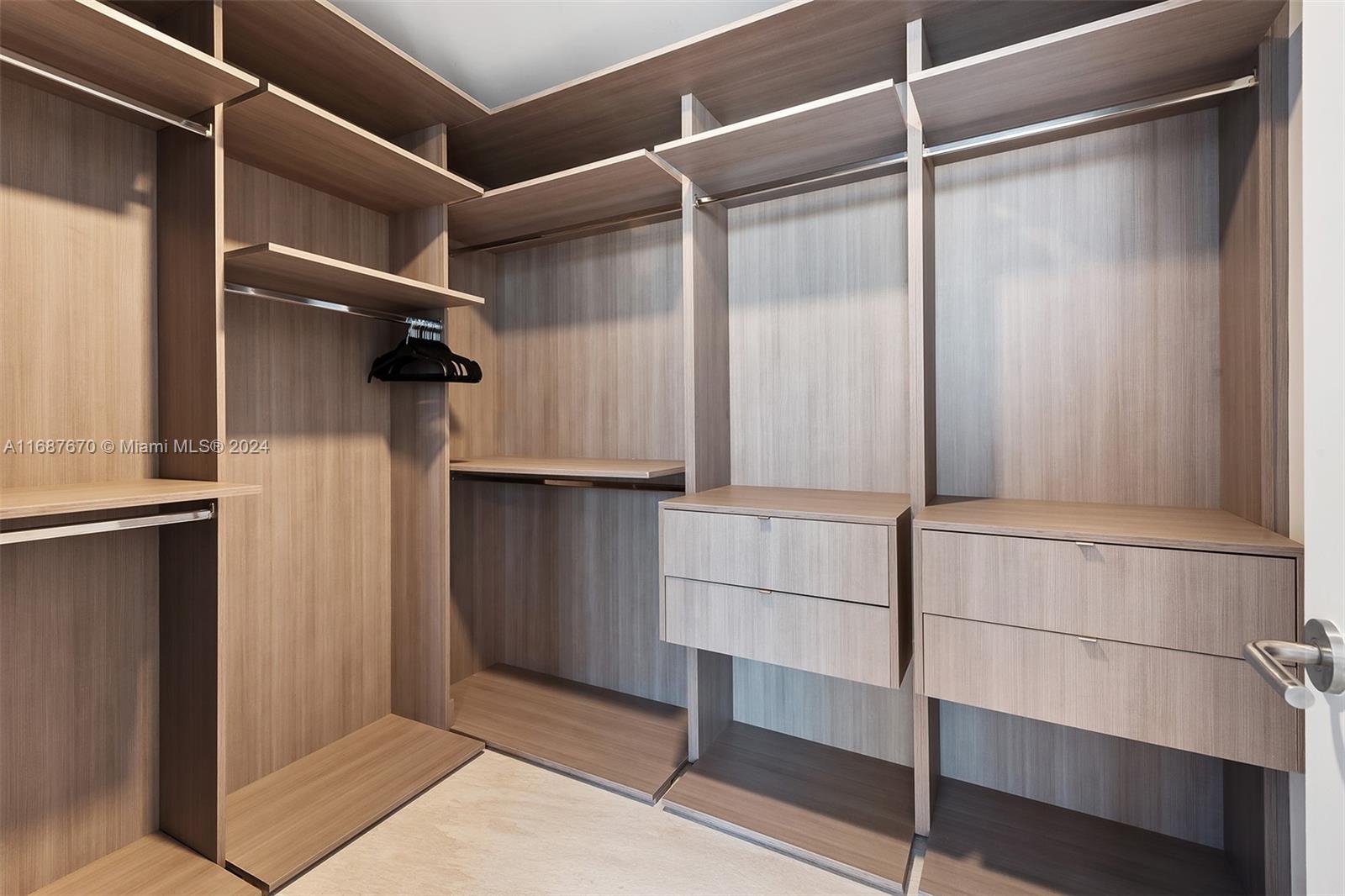 851 Northeast 1st Avenue, Unit PH5112 Miami, FL 33132 - Photo 26 of 77 a view of walk in closet with empty racks