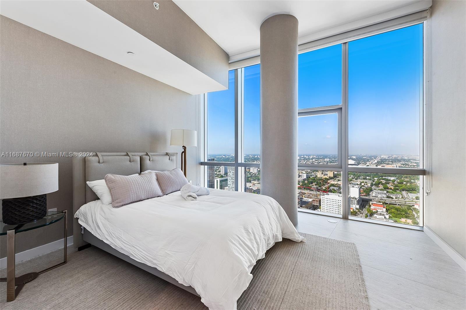 851 Northeast 1st Avenue, Unit PH5112 Miami, FL 33132 - Photo 32 of 77 a bedroom with a large bed and a large window