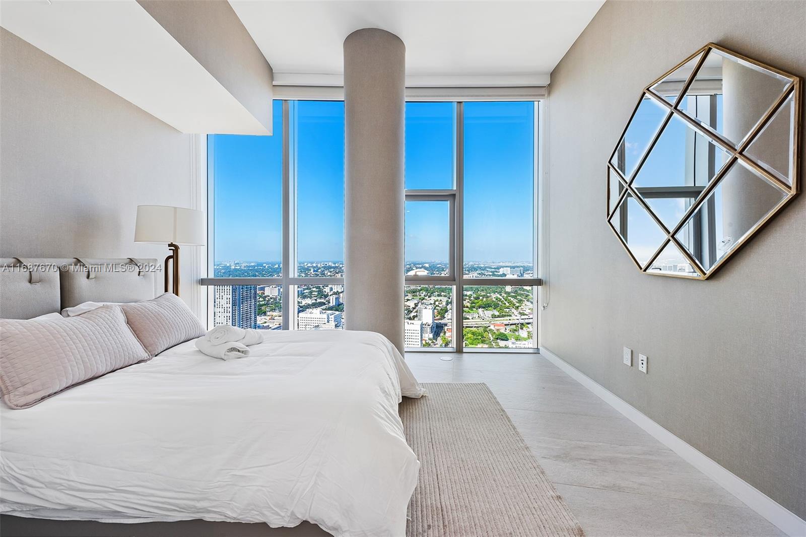 851 Northeast 1st Avenue, Unit PH5112 Miami, FL 33132 - Photo 33 of 77 a bedroom with a large bed and a window