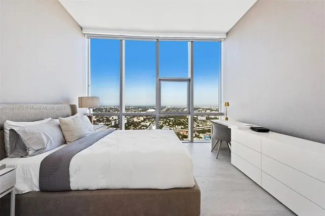 a bed room with a bed and a night stand