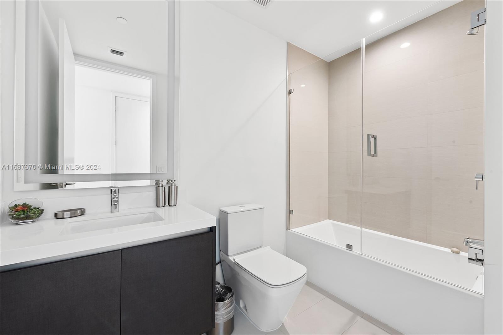 851 Northeast 1st Avenue, Unit PH5112 Miami, FL 33132 - Photo 40 of 77 a bathroom with a sink a toilet and shower