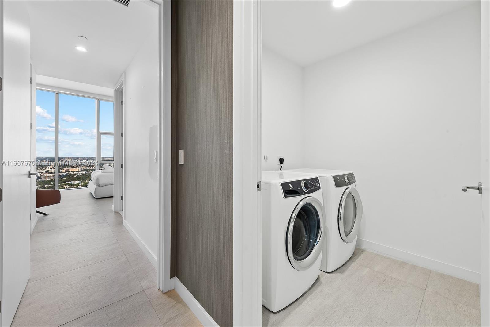 851 Northeast 1st Avenue, Unit PH5112 Miami, FL 33132 - Photo 41 of 77 a utility room with dryer and washer