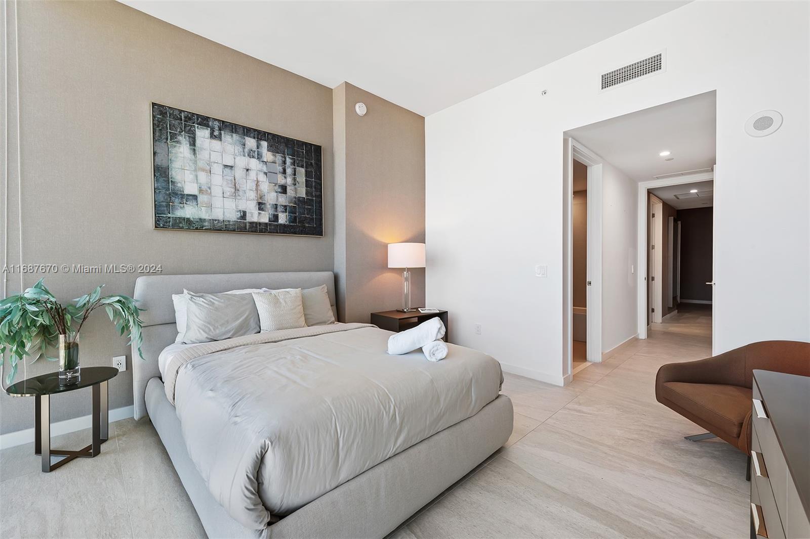 851 Northeast 1st Avenue, Unit PH5112 Miami, FL 33132 - Photo 45 of 77 a bedroom with a bed and a painting on the wall