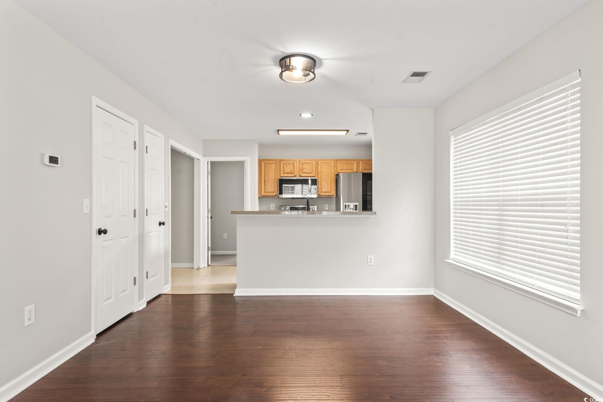 103 Barnacle Lane, Unit R5 Little River, SC 29566 - Photo 14 of 33 Unfurnished living room with dark wood finished floors and baseboards