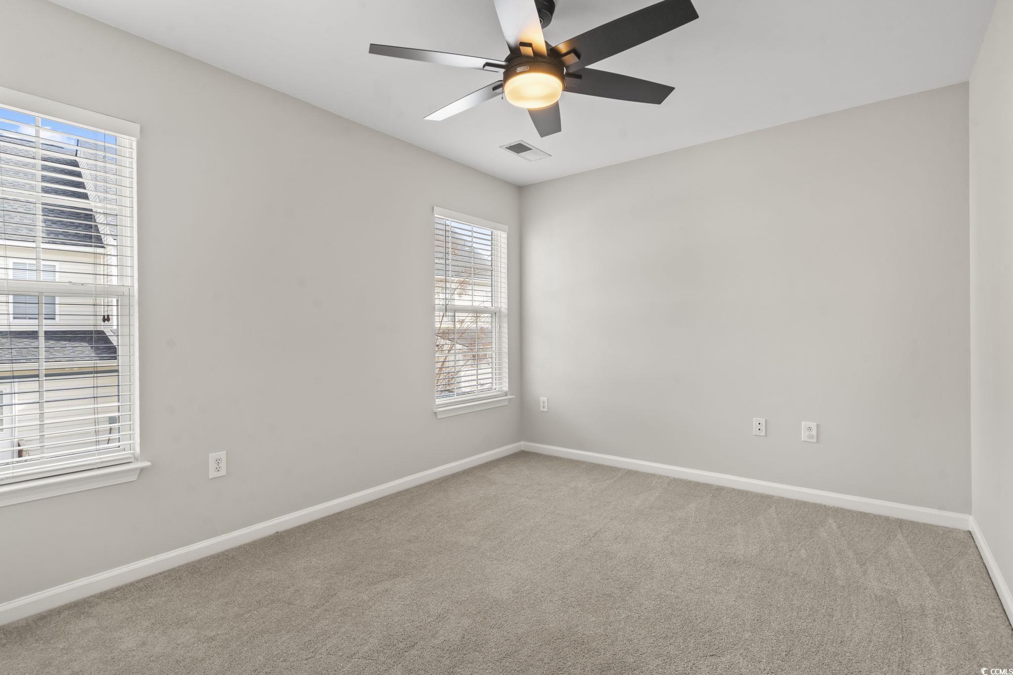 103 Barnacle Lane, Unit R5 Little River, SC 29566 - Photo 17 of 33 Empty room featuring light carpet and a ceiling fan