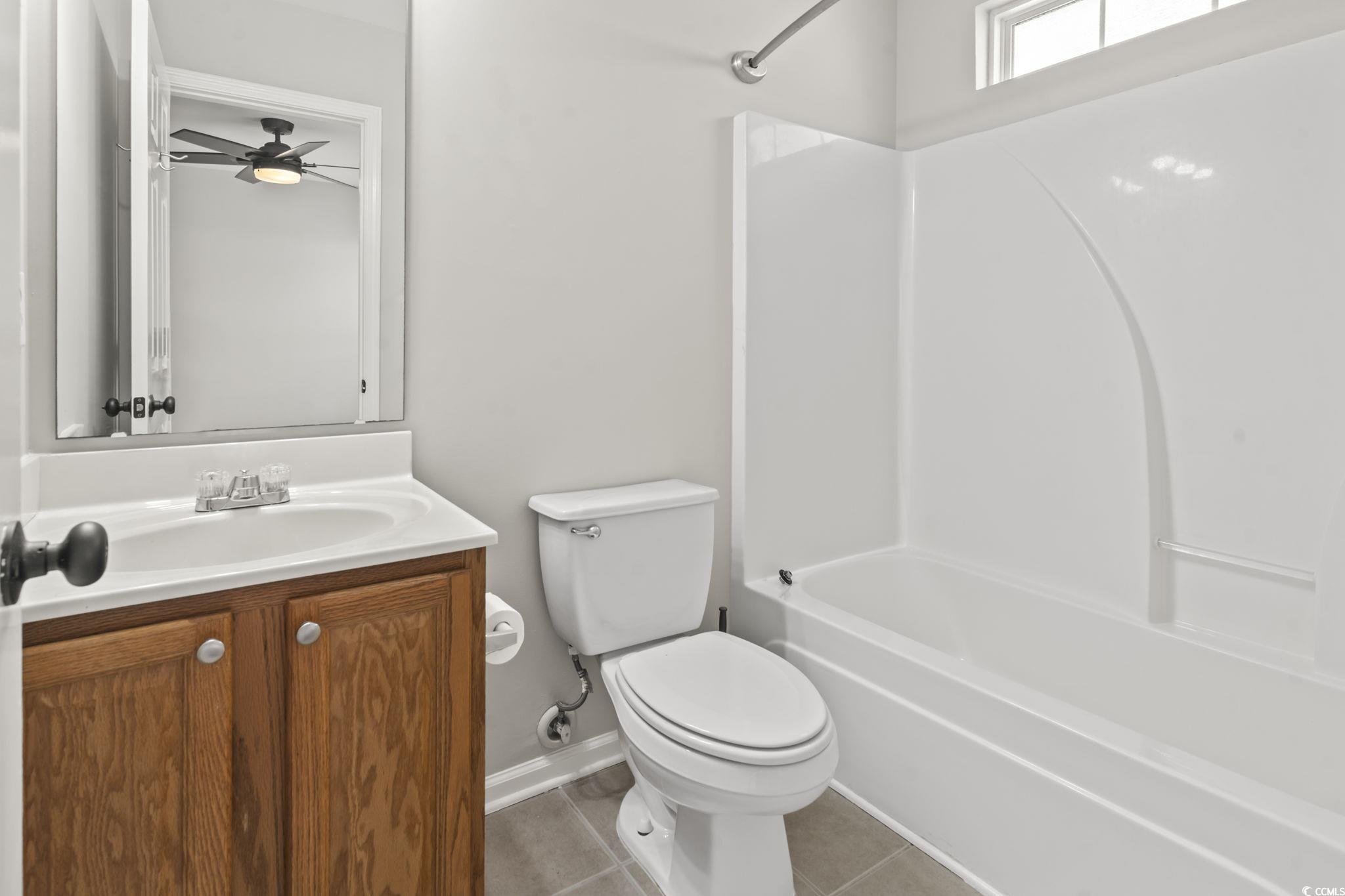 103 Barnacle Lane, Unit R5 Little River, SC 29566 - Photo 27 of 33 Full bathroom featuring vanity, light tile patterned floors, washtub / shower combination, and ceiling fan