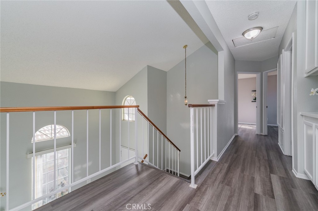 1955 Sierra Espadan Road Perris, CA 92571 - Photo 14 of 29 a view of a hallway with wooden floor and staircase