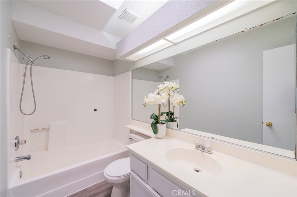 1955 Sierra Espadan Road Perris, CA 92571 - Photo 19 of 29 a bathroom with a sink vanity mirror and toilet