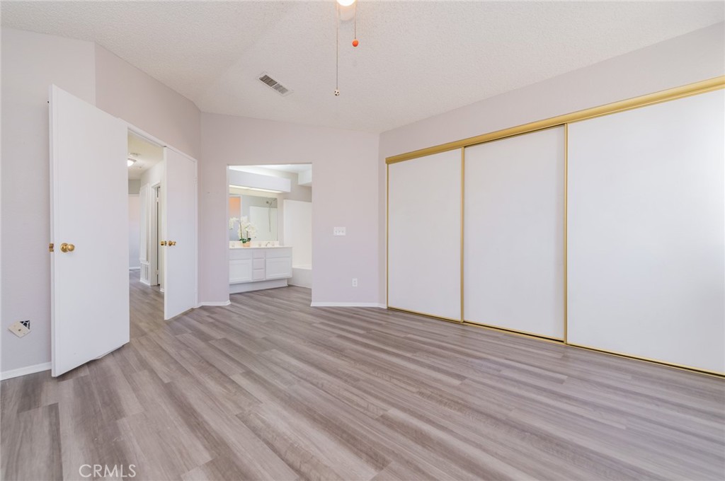 1955 Sierra Espadan Road Perris, CA 92571 - Photo 21 of 29 a view of an empty room with wooden floor and a window